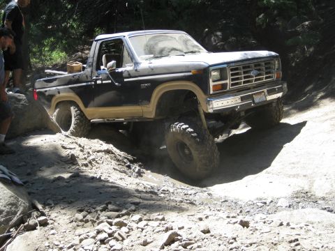 1986 Ford Bronco - This Ford Bronco navigates a challenging off-road course with large tires and a lifted suspension.