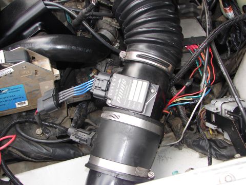 1992 Ford Taurus - The engine's air intake system, including the mass air flow sensor and associated wiring, is shown in this close-up view.