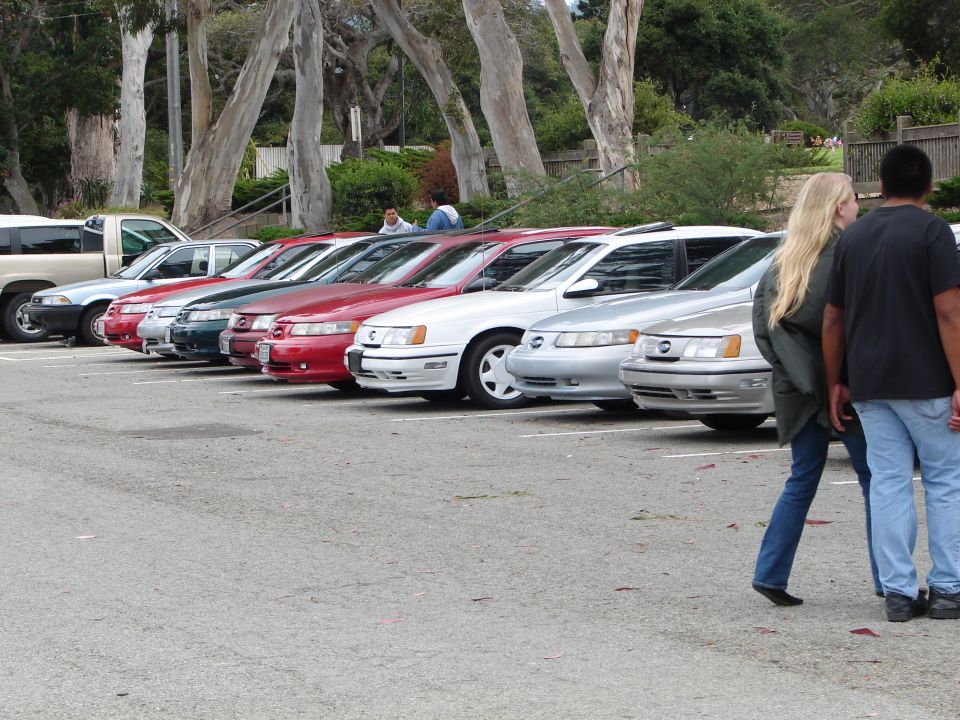 Silver 1992 Ford Taurus parked in a line of cars, side view
