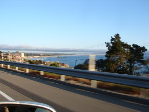 1992 Ford Taurus - Driving along the coast with a view of the ocean and a town in the distance.