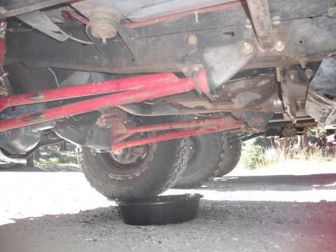 1991 Ford Bronco - Undercarriage view of a vehicle, focusing on suspension and drivetrain components.