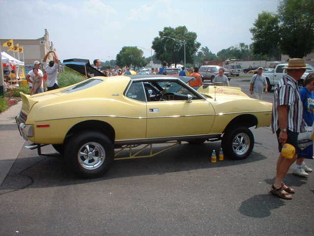 Yellow AMC Javelin with large rear tires and drag racing suspension, parked outdoors