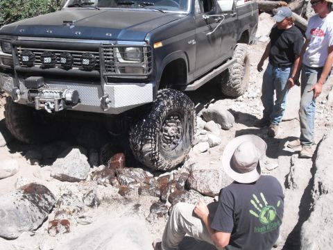 1991 Ford Bronco - This modified pickup truck navigates a challenging rocky terrain, its off-road capabilities.