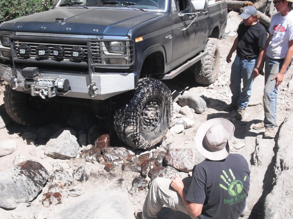 Dark blue pickup truck with winch and auxiliary lights on a rocky trail