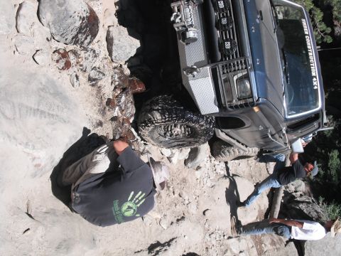 1991 Ford Bronco - Off-road vehicle with winch and custom bumper on a challenging rocky trail.