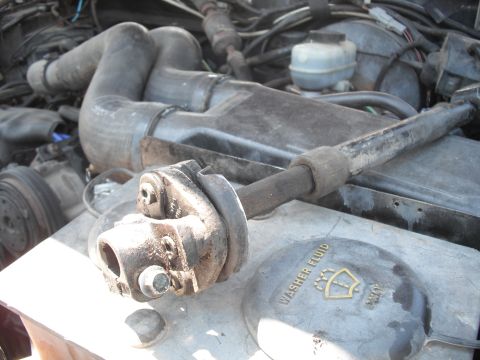 1991 Ford Bronco - Engine parts and a washer fluid cap are visible in this close-up view.