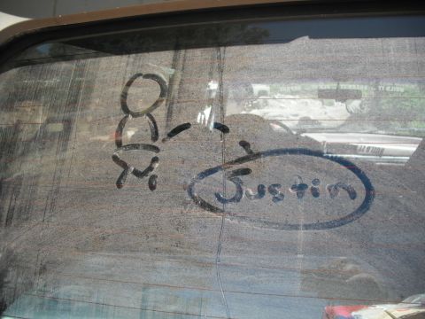 1991 Ford Bronco - A drawing on a dirty car window shows a baby and the name Justin.