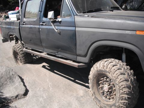 1991 Ford Bronco - This heavily modified truck features large tires and custom side steps, suggesting it's built for off-road use.