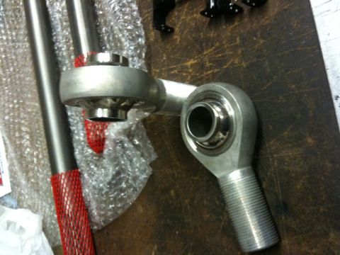 1987 Suzuki Samurai - Close-up of automotive suspension linkage parts, likely for aftermarket modification.