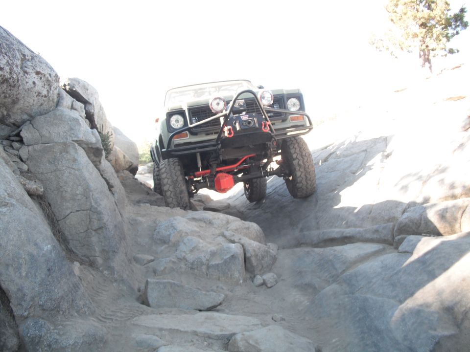 Off-road vehicle with winch climbing rocky terrain