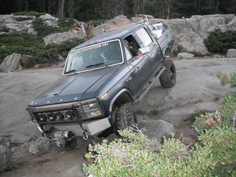 1991 Ford Bronco - This modified Ford pickup truck is shown off-roading on a rocky trail.