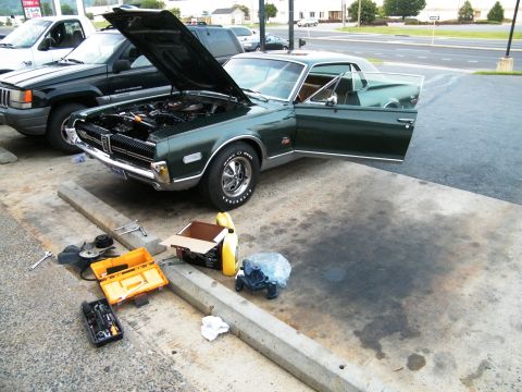 1968 Mercury Cougar - Green 1968 Mercury Cougar with hood and door open, parked next to a Jeep. Tools and fluids are on the ground.