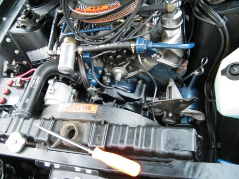 1968 Mercury Cougar - Close-up view of a vehicle's engine compartment, showing the air cleaner, radiator, and fan.