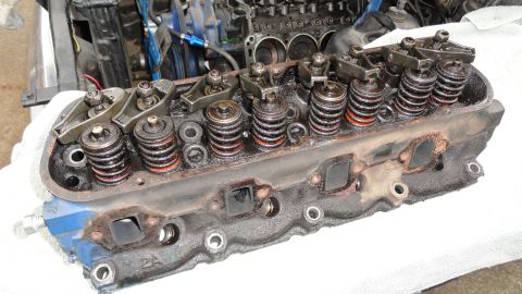 1964 Ford Fairlane - Close-up of an engine cylinder head, showing valve springs and rocker arms. A partial part number '2A' is visible on the casting.