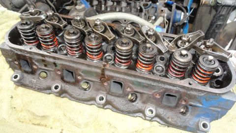 1964 Ford Fairlane - Close-up of an engine cylinder head with visible valve springs and rocker arms.