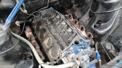 1964 Ford Fairlane - Close-up view of a disassembled engine block, showing pistons and cylinder bores.