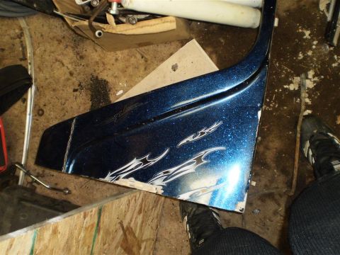 1978 Ford Bronco - A blue fender with flame decals and glitter paint is shown, with visible damage along its edge.