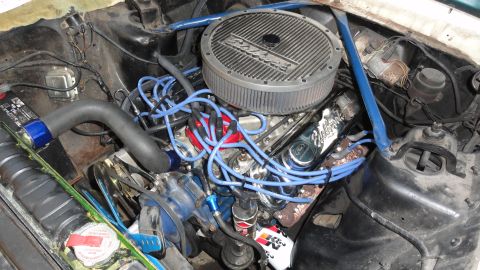 1964 Ford Fairlane - Close-up view of a modified engine bay, showing various aftermarket parts and wiring.