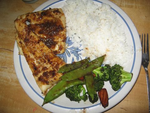 1996 Ford Bronco - A meal of rice, fish, snap peas, and broccoli is served on a plate with a blue and white rim.