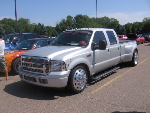 2001 Chevrolet Silverado 1500 - Silver Ford F-350 Super Duty dually pickup truck parked in a lot with other vehicles.