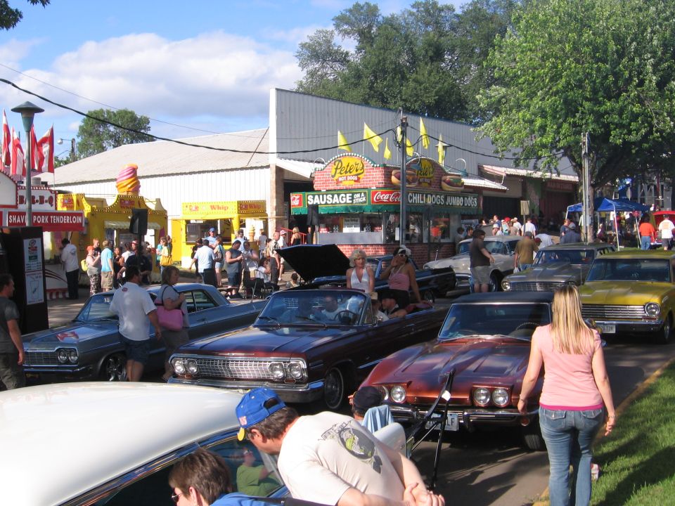 Classic cars on display at an outdoor street car show