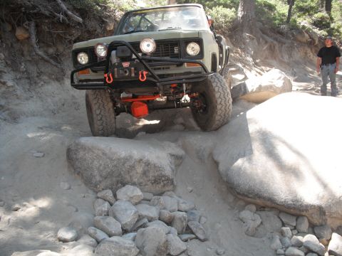 1991 Ford Bronco - This modified truck is navigating a challenging rocky trail, demonstrating its off-road capabilities.