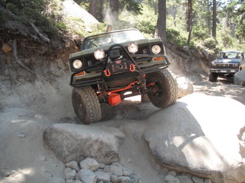 1991 Ford Bronco - A modified 1978 International Harvester Scout II navigates a rocky trail, with another truck following behind.