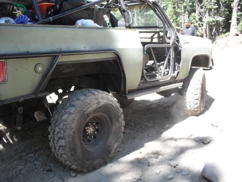 1991 Ford Bronco - This heavily modified SUV features a prominent roll cage and off-road tires, suggesting it is built for terrain.