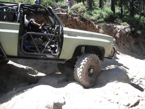 1991 Ford Bronco - This modified off-road vehicle is shown tackling a challenging rocky path.