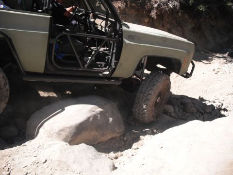1991 Ford Bronco - This vehicle is equipped with a roll cage and large tires for off-road use.