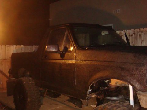 1992 Ford Bronco - The side of a Ford Bronco is shown, appearing to be undergoing restoration or modification.