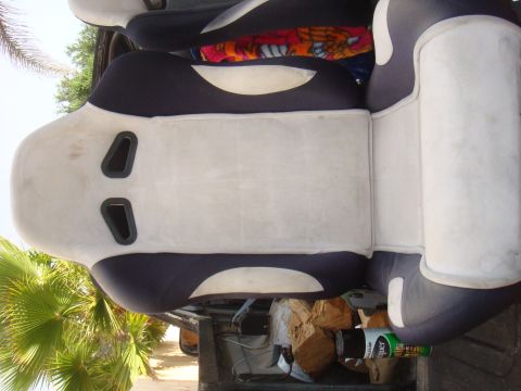 1992 Ford Bronco - Interior view of car seats, some with cutouts for racing harnesses, in what appears to be a vehicle's cabin.