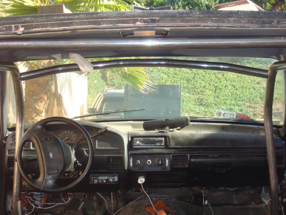 1992 Ford Bronco interior with roll cage, dashboard, and steering wheel visible