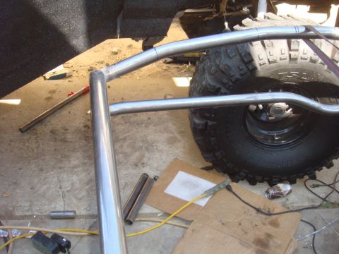 1992 Ford Bronco - Roll cage installation in progress, showing tubing and a large tire.