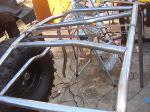 1992 Ford Bronco - Custom roll cage fabrication in progress, with a large tire visible.