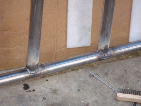 1992 Ford Bronco - Welded metal tubing shown in detail, with cardboard and concrete in the background.