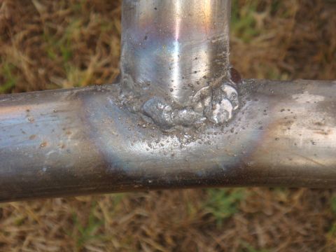 1992 Ford Bronco - Close-up of welded metal tubing, showing the texture and color variations from the welding process.