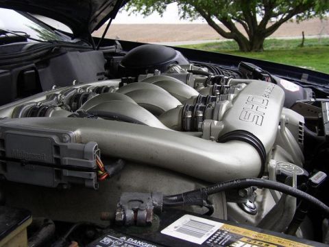 1993 Ford Taurus - Engine bay view of a 1993 Ford Taurus SHO, highlighting the V6 engine and "SHO" badging.