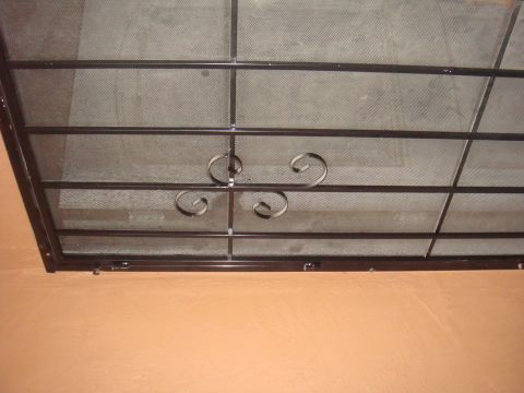 1992 Ford Bronco - Decorative window security bars are installed over a screened window.