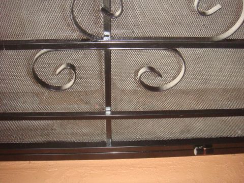 1992 Ford Bronco - This photo shows a decorative metal screen with ornate scrollwork and a mesh backing.