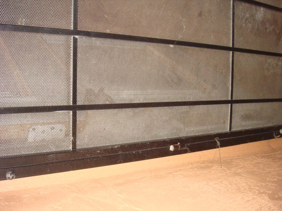 Metal cage with black frame and mesh panels, viewed from a low angle