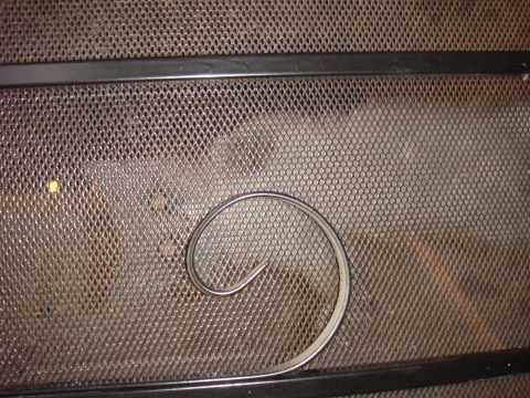 1992 Ford Bronco - Metal mesh screen with a decorative curved metal piece and Supermotors.net logo.