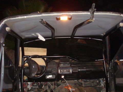 1992 Ford Bronco - The interior of a 1992 Ford Bronco shows a roll cage and modifications.