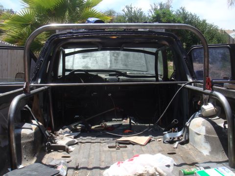 1992 Ford Bronco - Interior view of a truck bed with a custom roll cage, showing the dashboard and seats.