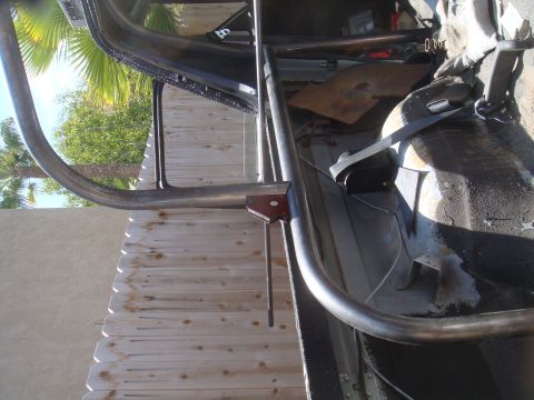 1992 Ford Bronco - Interior view of a vehicle's roll cage, with exterior elements visible through the windows.
