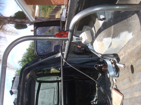 1992 Ford Bronco - Interior view of a vehicle's roll cage and seatbelt system.