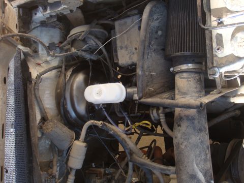 1992 Ford Bronco - Close-up of an engine bay, focusing on the brake booster and air intake system.