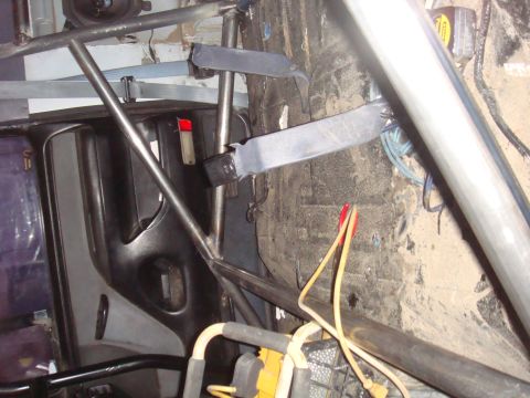 1992 Ford Bronco - Roll cage and seatbelt mounting points visible inside a vehicle's interior.