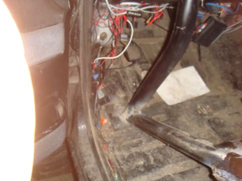 1992 Ford Bronco - The interior of the vehicle shows a roll cage and exposed wiring, with debris scattered on the floor.