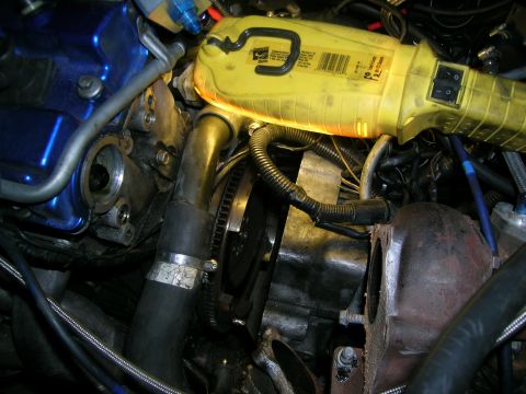 1995 Ford Probe - Close-up view of an engine bay, focusing on a turbocharger installation with a yellow work light illuminating the components.